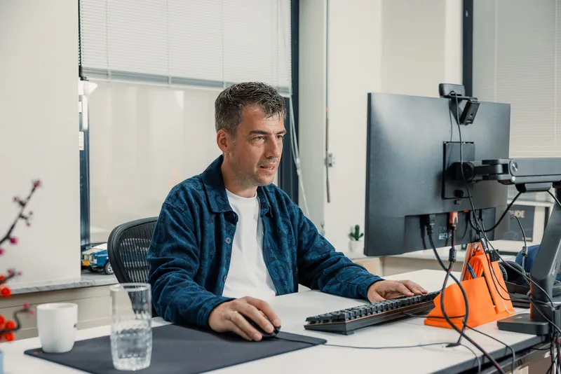 At the desk, mid-conversation